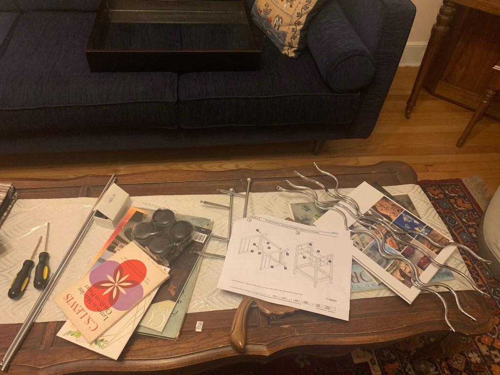 The pieces of my bar cart are lying across the coffee table and couch in my living room.